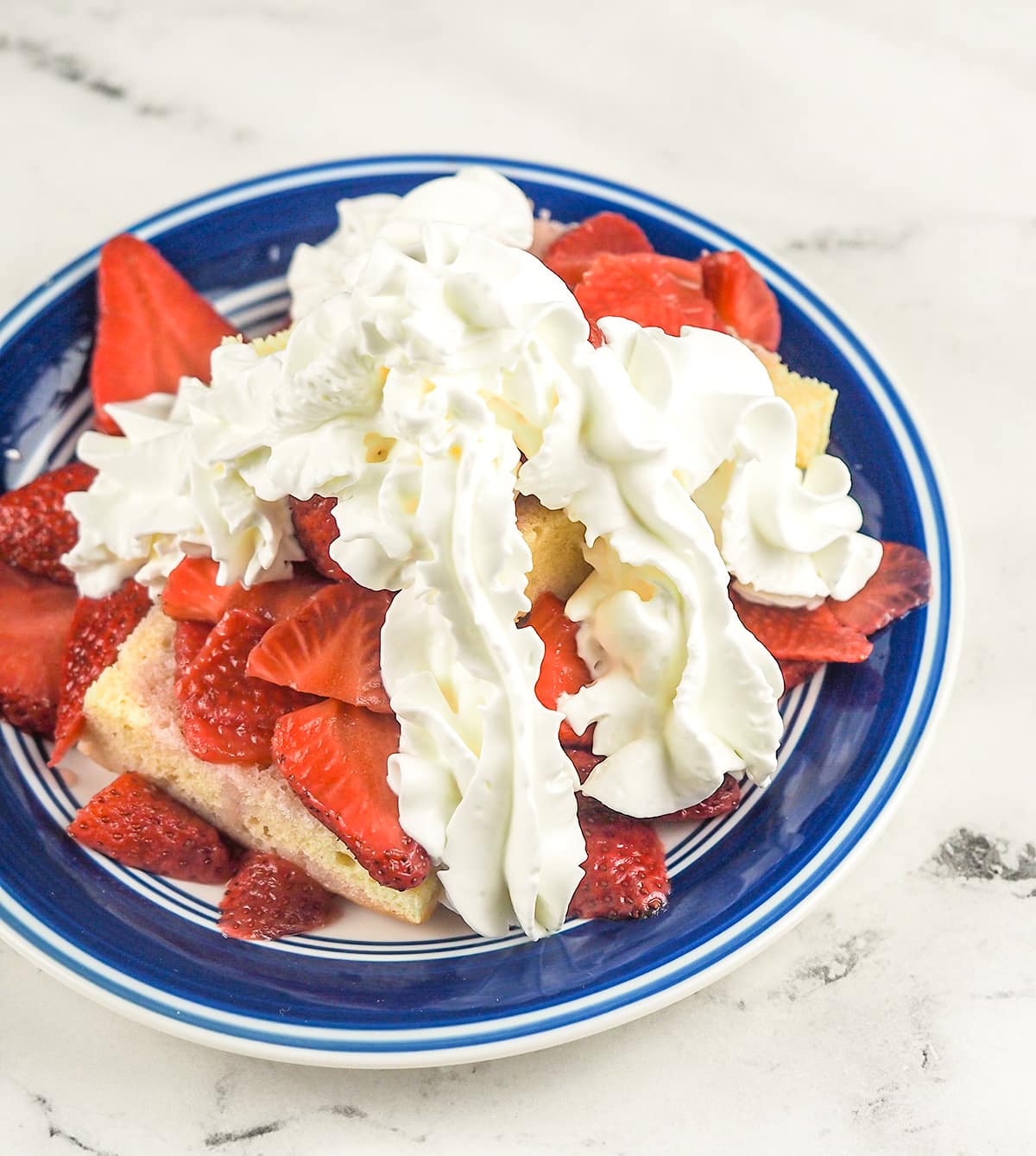 strawberry shortcake on blue rimmed plate