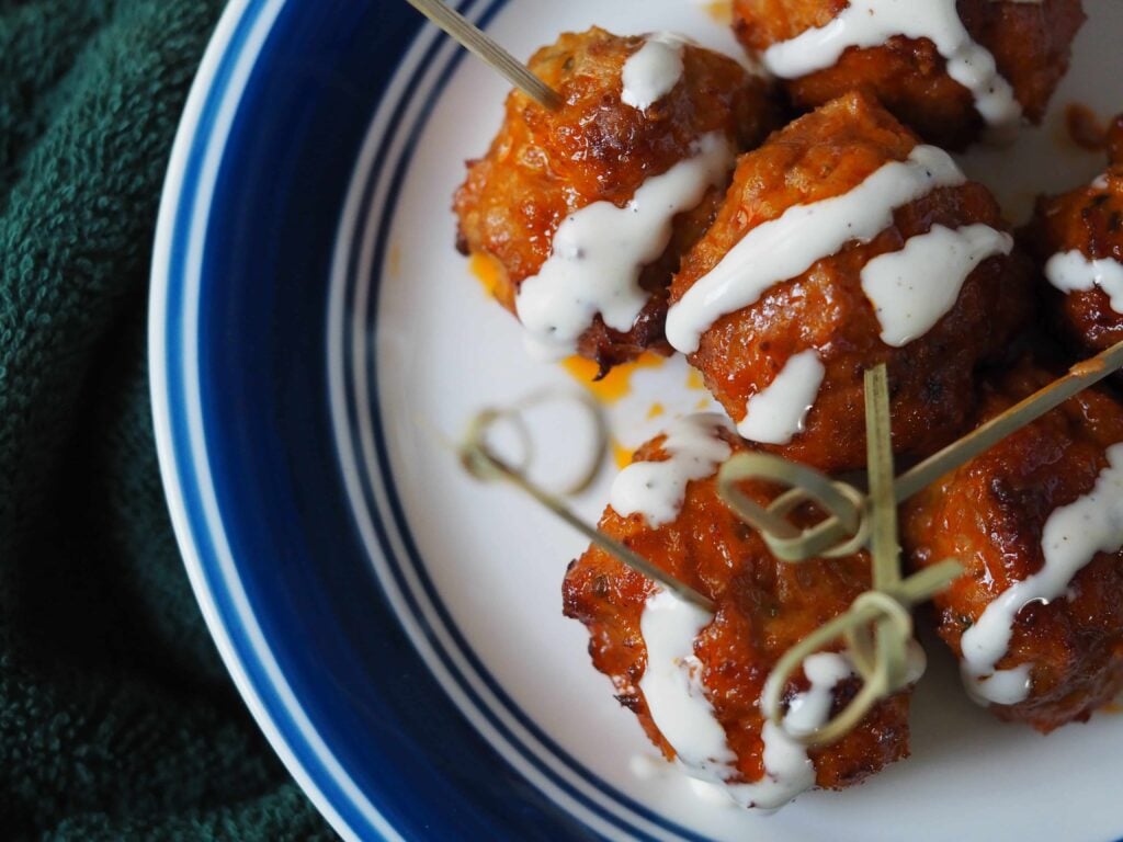 buffalo meatballs on blue rimmed plate