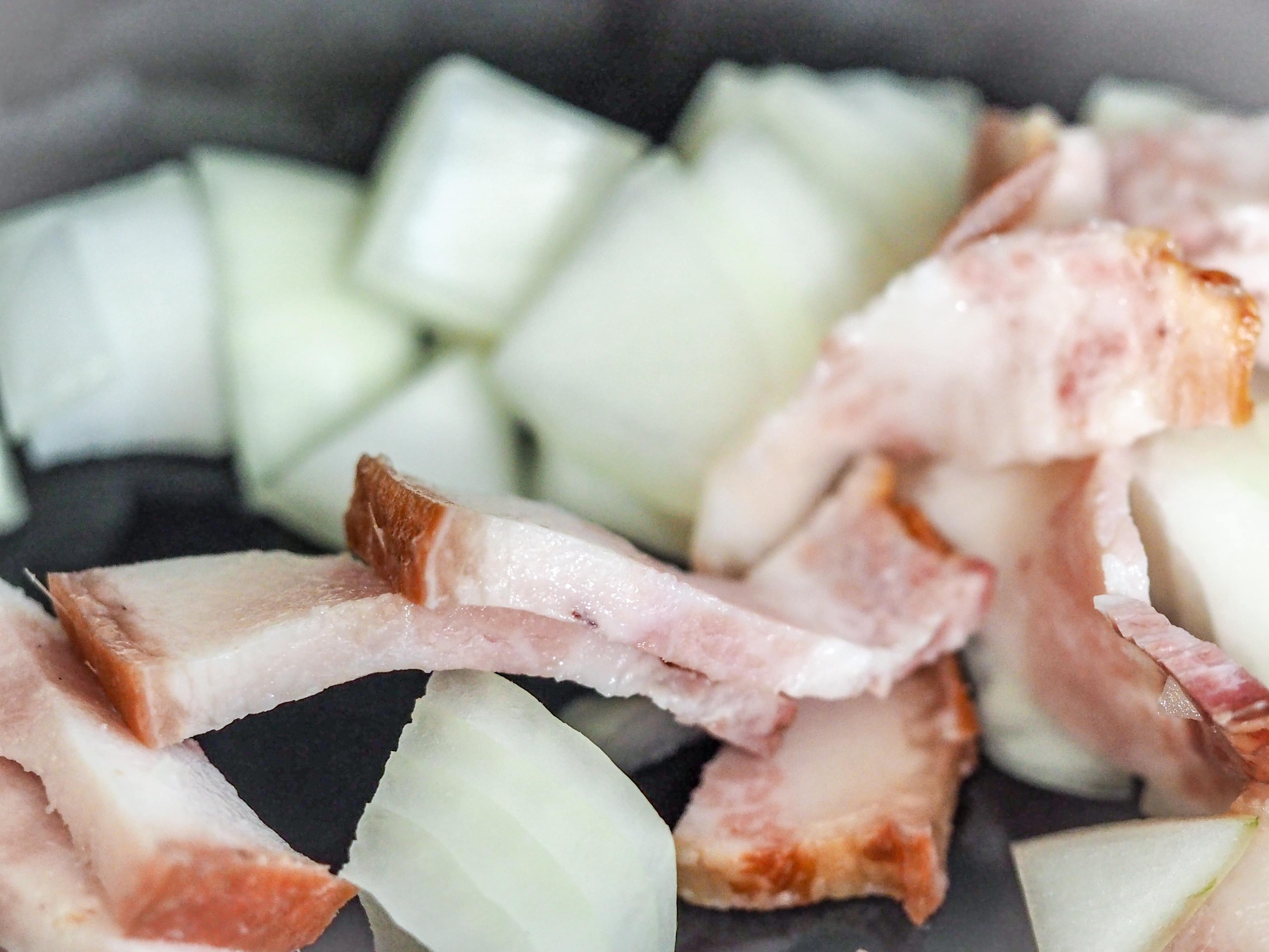 close view of  sliced bacon and chopped onions
