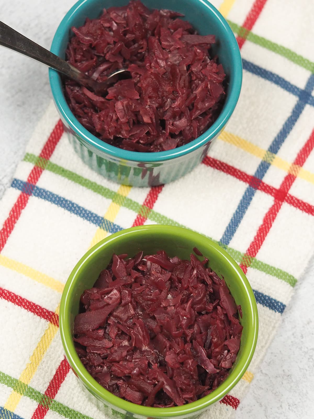 two bowls of red cabbage on towel