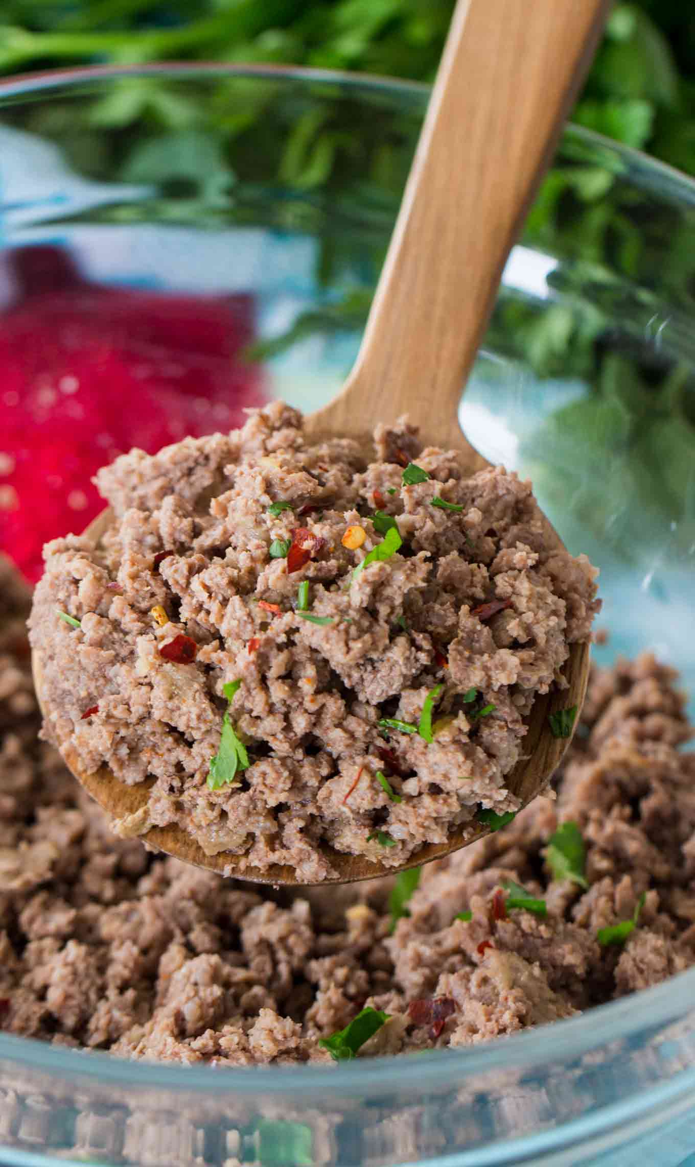 cooked seasoned ground beef in a bowl with wooden spoon