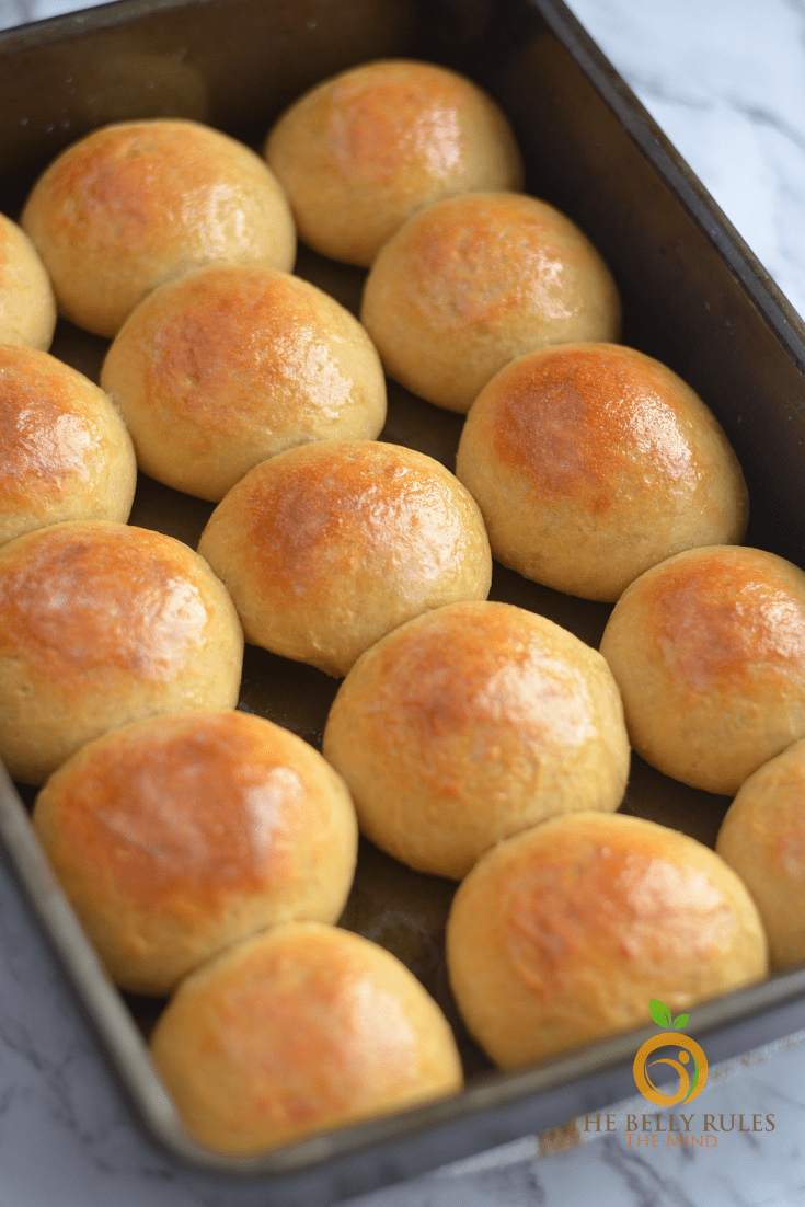baked dinner rolls in a pan on a marble countertop