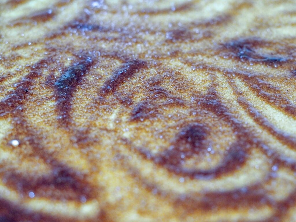Pie crust rolled out with butter, sugar, and cinnamon in a swirled pattern