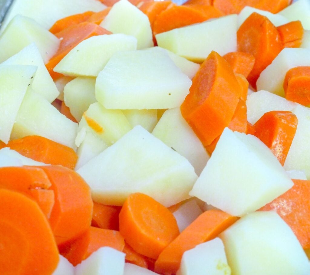 peeled and diced potatoes and carrots in a saucepan