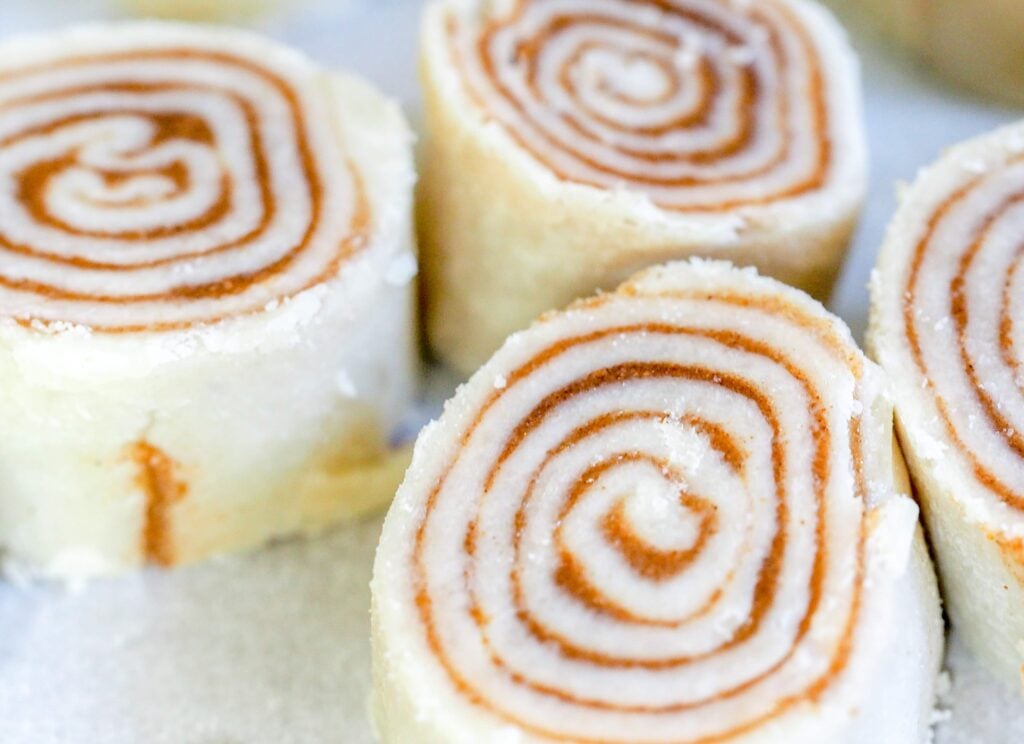cinnamon roll pinwheel pie pastry sitting on a counter in a group of three