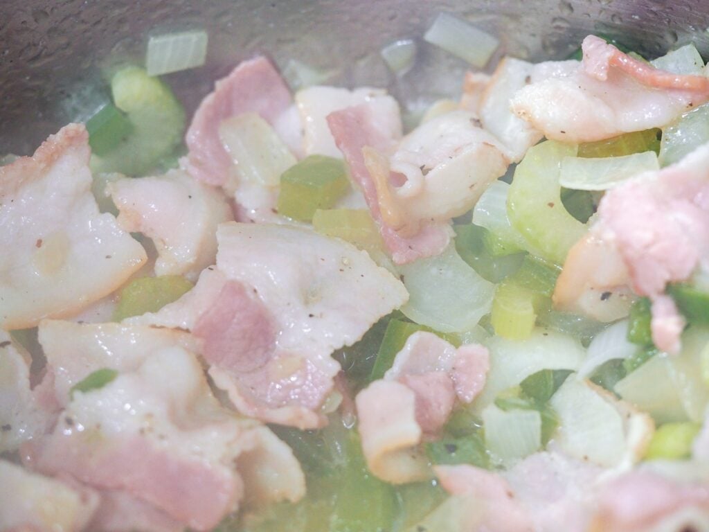 diced bacon and vegetables in pan