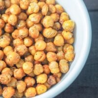 overhead close-up shot of air fried chickpeas in a white bowl on a rustic table