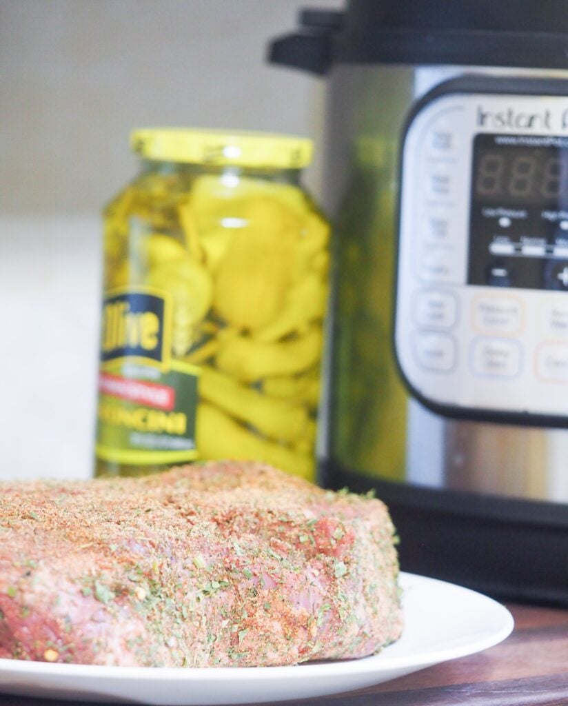 chuck roast on plate on cutting board in front of instant pot