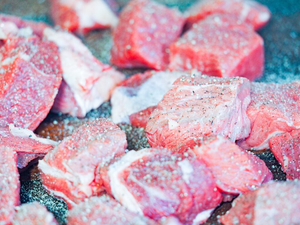 close view of cubed sirloin beef that has been seasoned