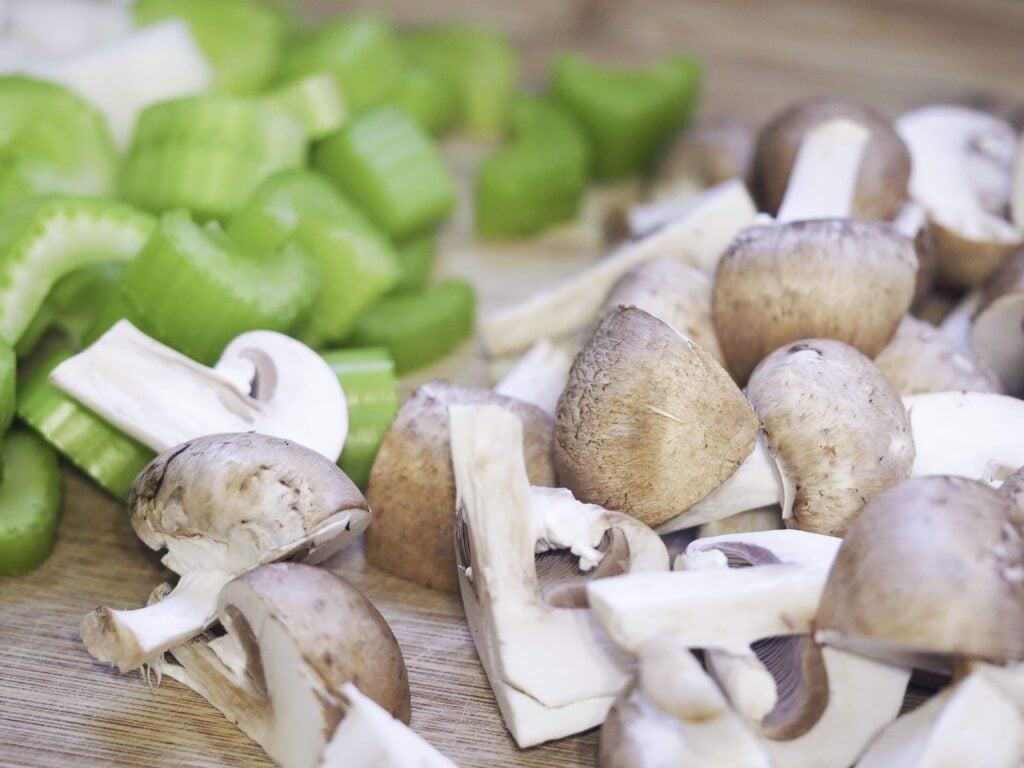 close view of prepped celery, onioins, and mushrooms