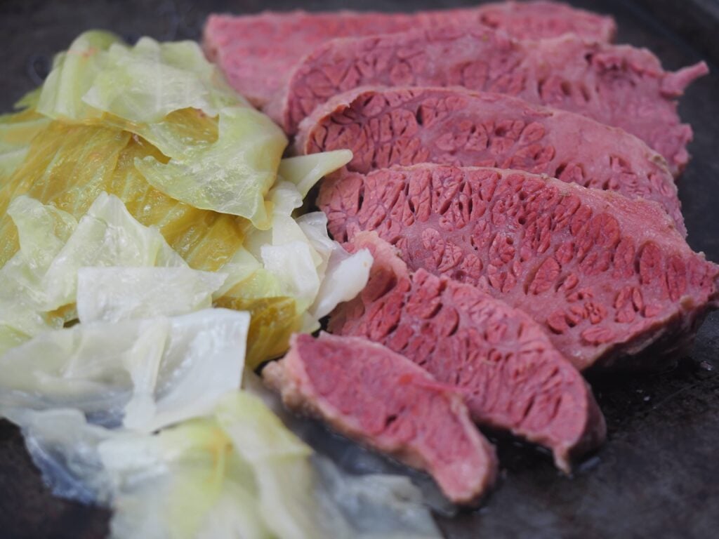 sliced corned beef with cabbage on baking pan