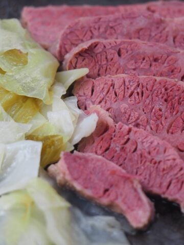 sliced corned beef with cabbage on baking pan