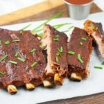 ribs on cutting board on top of parchment paper