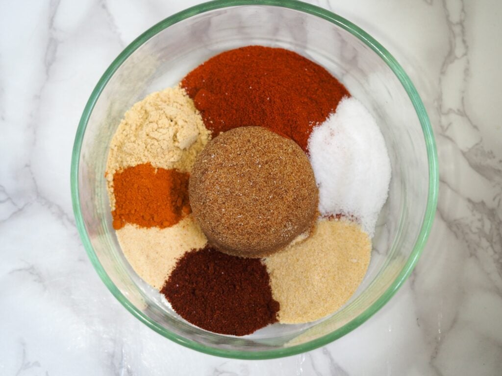 overhead shot of seasoning in clear bowl on marble  countertop