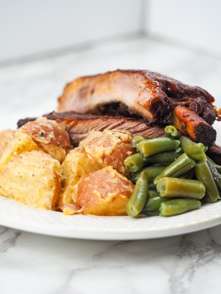 Plate with ribs, green beans,and cheesy potatoes