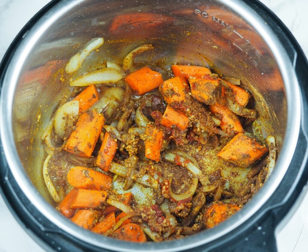 overhead view of cooked vegetables in the pressure cooker with spices