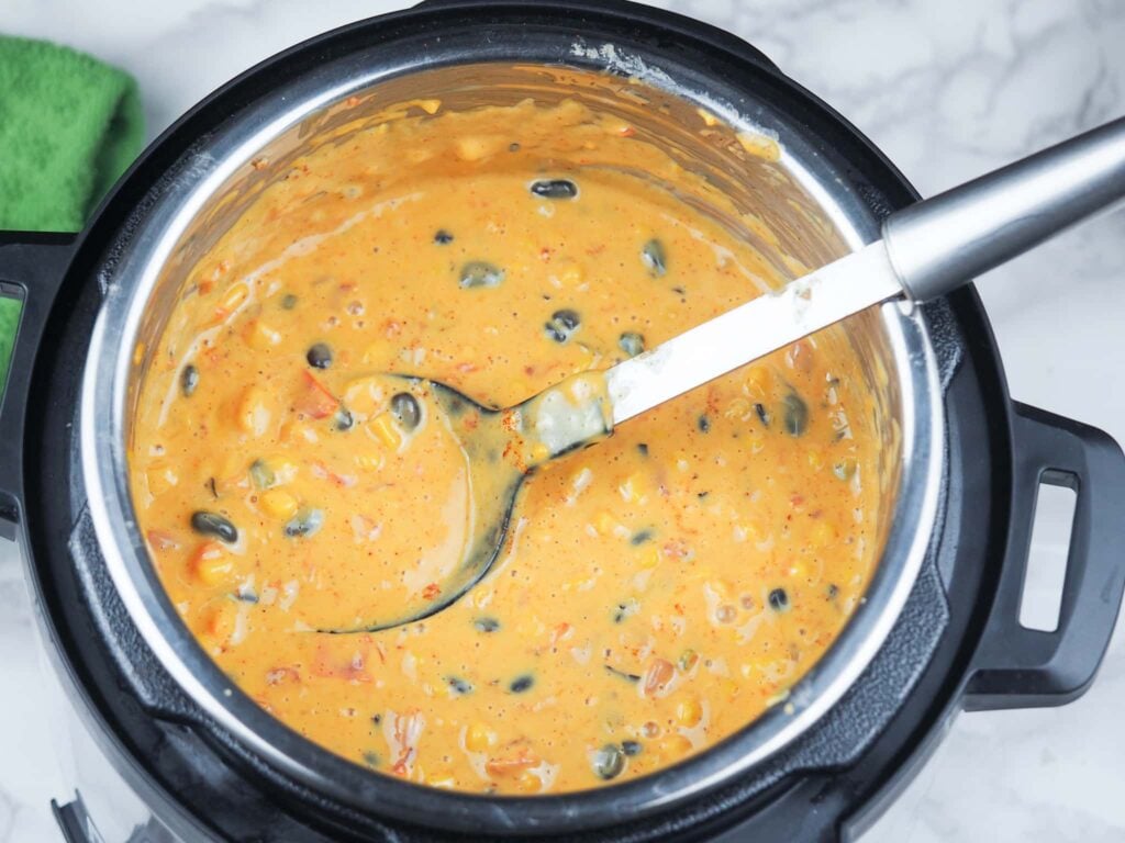 overhead view of queso ingredients cooked and melted in instant pot