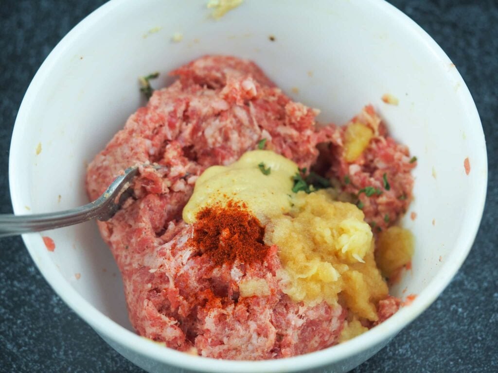 breakfast sausage ingredients in small white mixing bowl