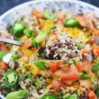 close view of beef rice a roni on spoon in front of bowl