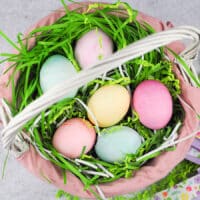 overhead of colored eggs in basket