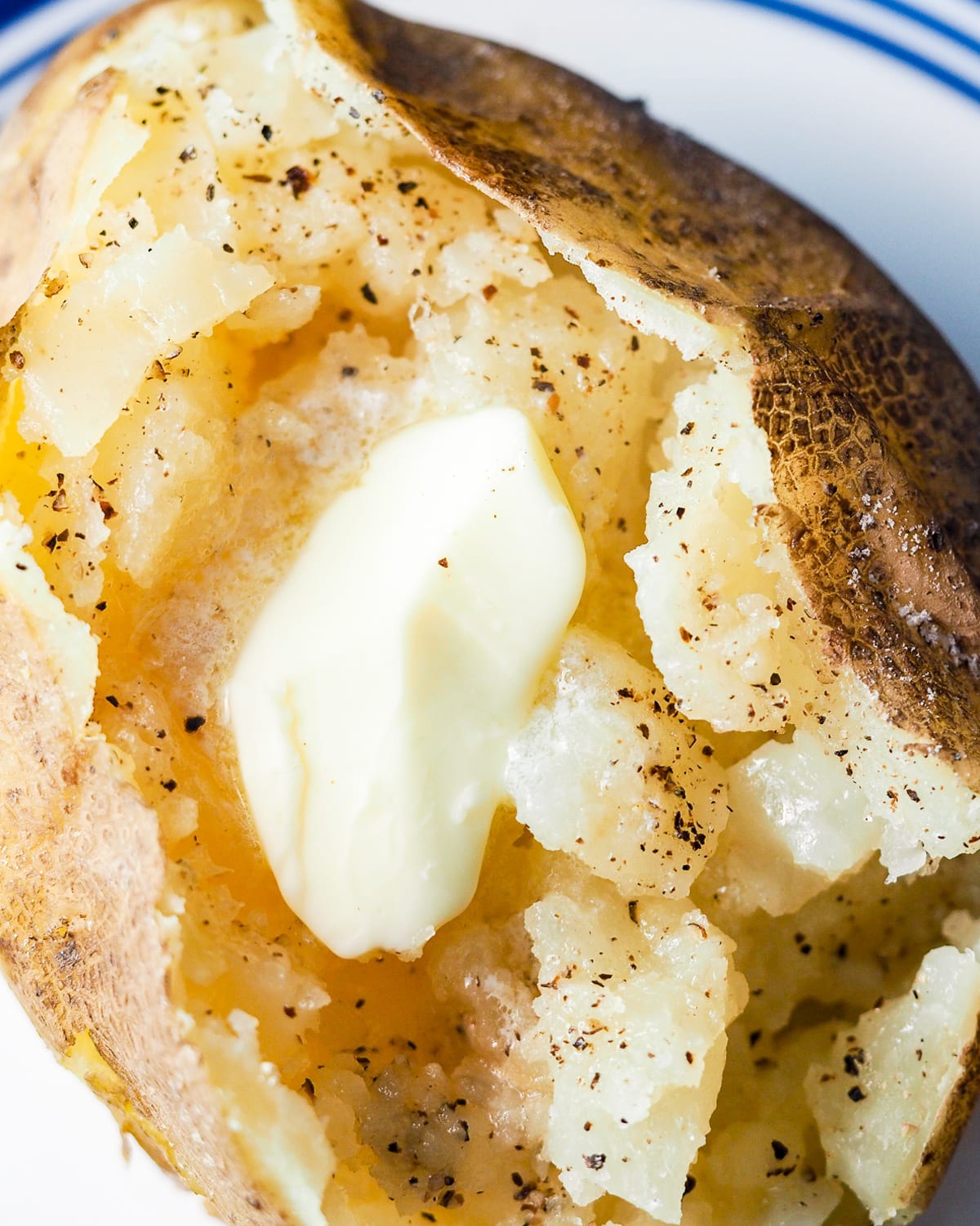 baked potato topped with butter, salt, and pepper