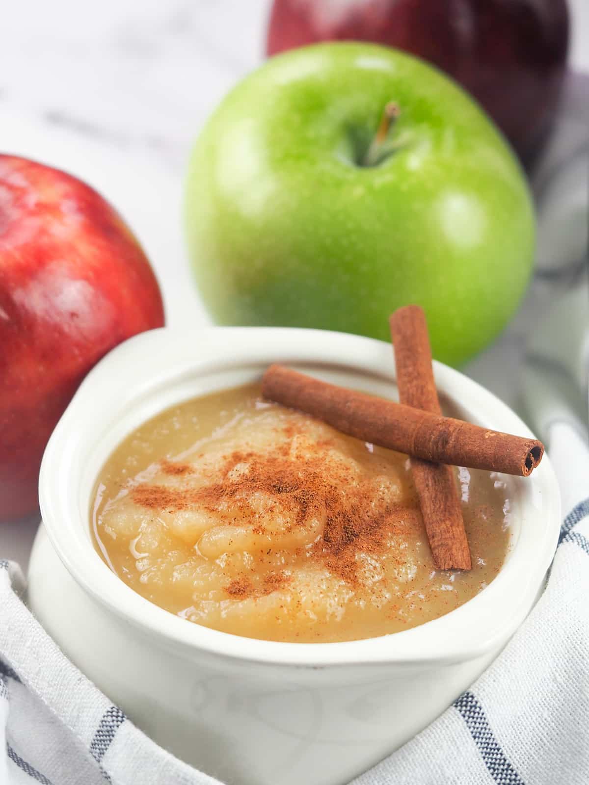 applesauce in white crock with apples