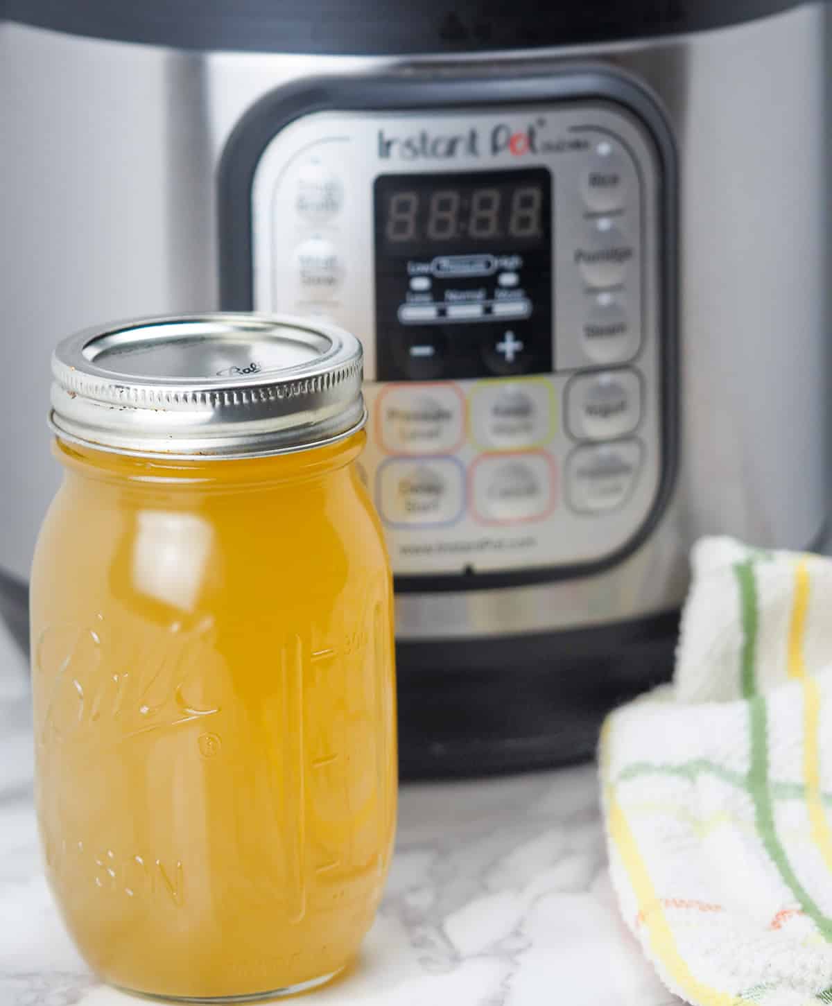 jar of chicken bone broth in front of instant pot