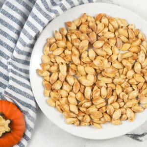 roasted pumpkin seeds on plate with towel