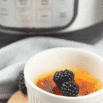 creme brulee in white ramekin in front of instant pot