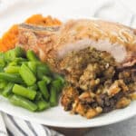 stuffed pork chop on plate with green beans