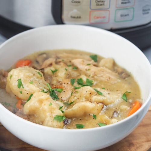 stew in a white bowl on cutting board