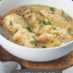 instant pot chicken and dumplings in white bowl next to instant pot