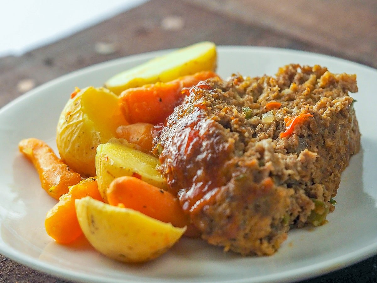 MEATLOAF WITH POTATOES AND CARROTS ON WHITE PLATE