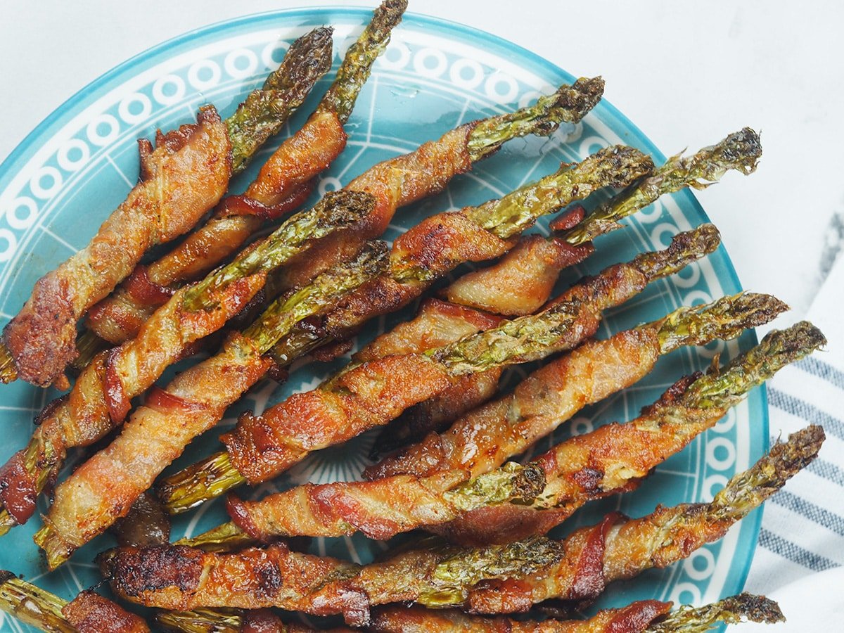 asparagus wrapped in bacon on plate