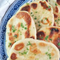 homemade naan bread topped with parsley