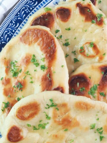 homemade naan bread topped with parsley