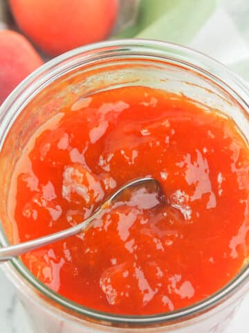 apricot jam in jar with spoon