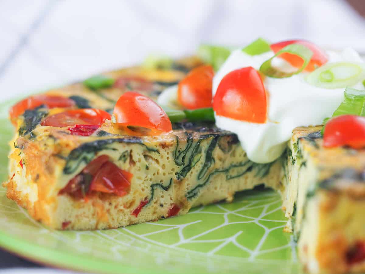 frittata on plate with wedge cut out