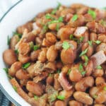 pinto beans in bowl topped with parsley