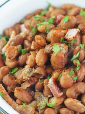 pinto beans in bowl topped with parsley