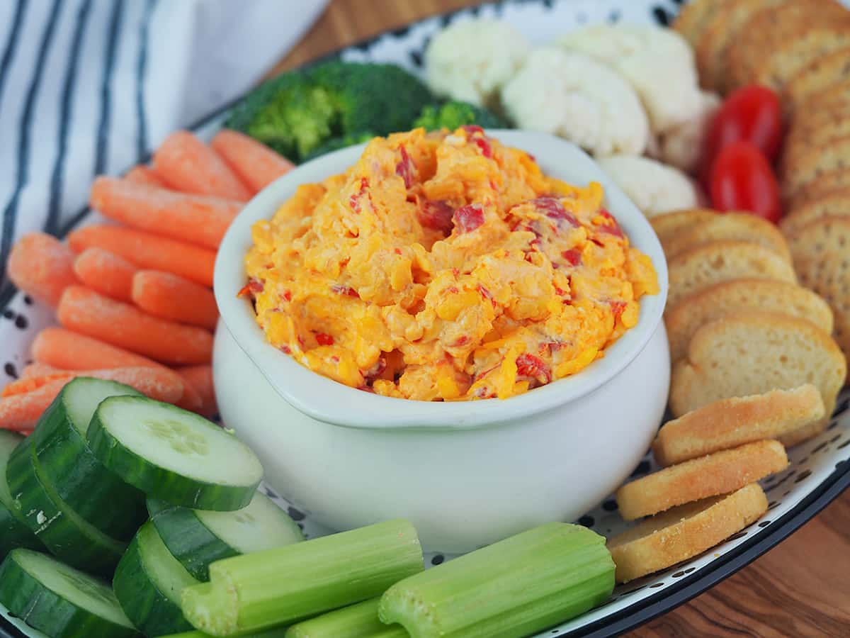 pimento cheese spread in crock on vegetable platter