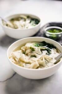 Wonton soup in bowl with bok choy.