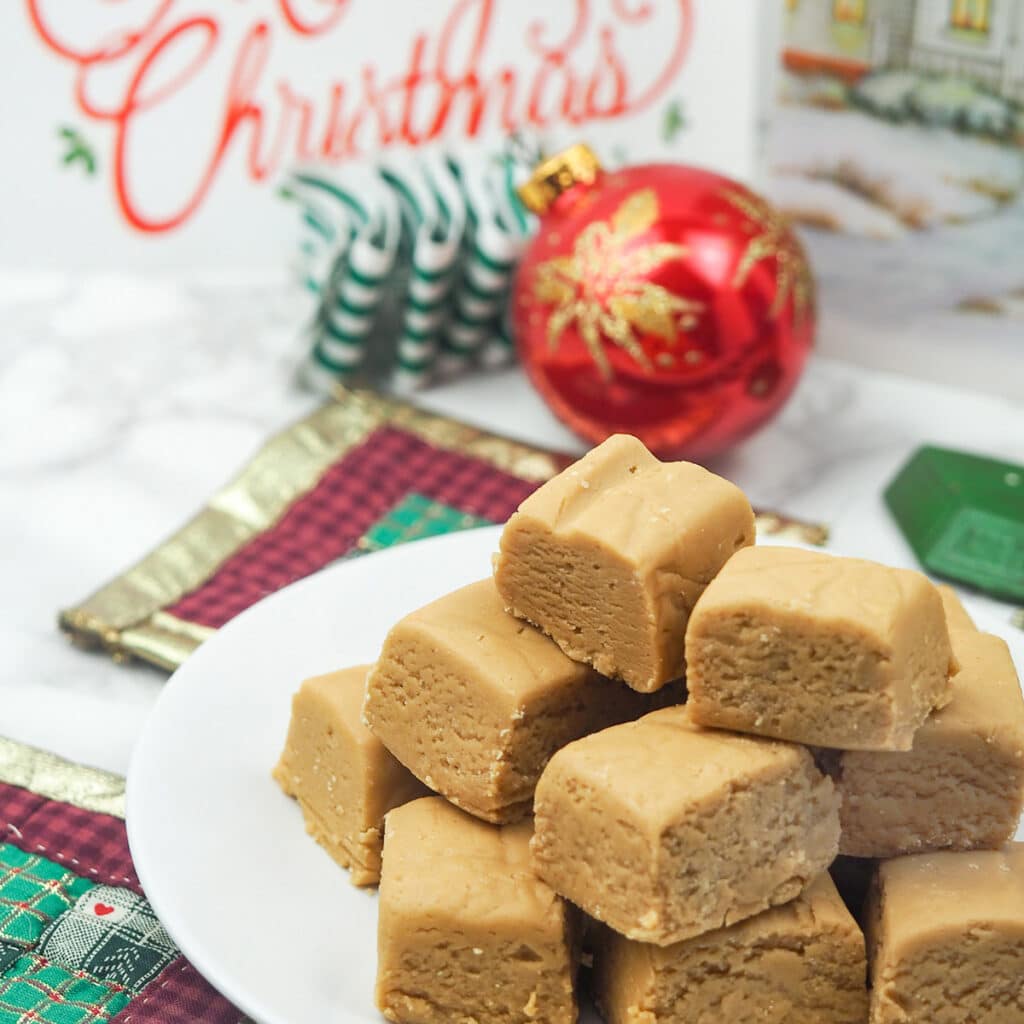 peanut butter fudge on white plate with ornaments