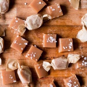 Salted caramels on wooden board.