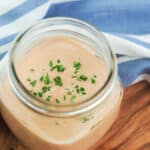 Comeback sauce in a pint mason jar with parsley sprinkled on top.