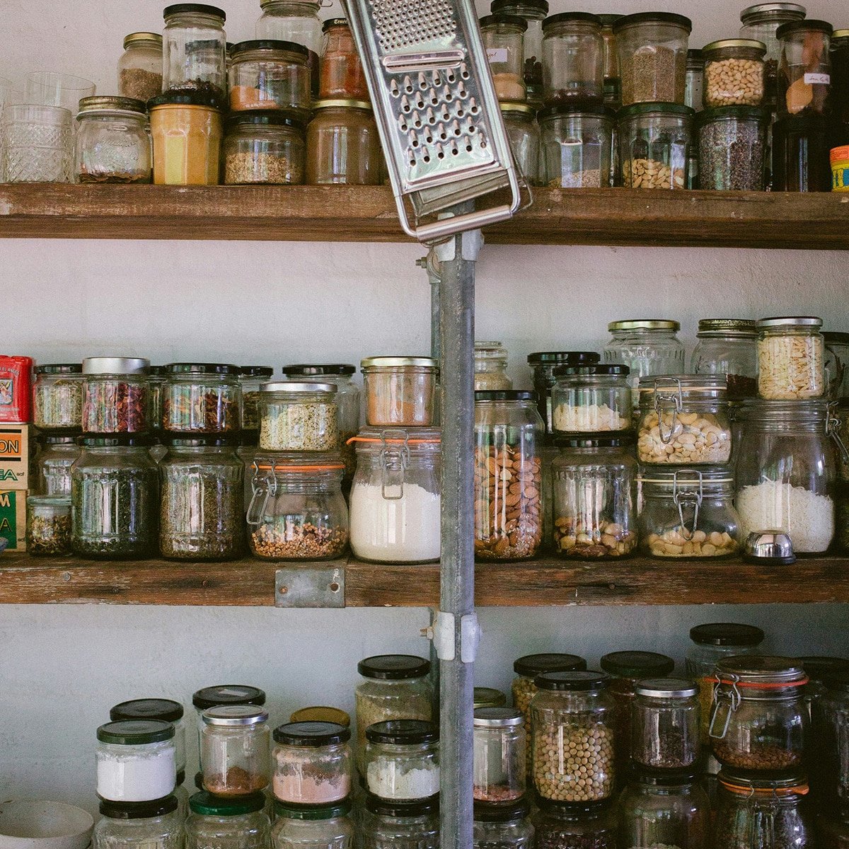 Pantry with glass jars on wooden shelves