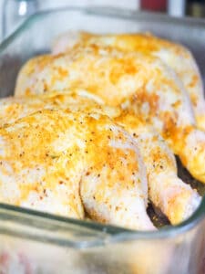 seasoned leg quarters in glass baking pan